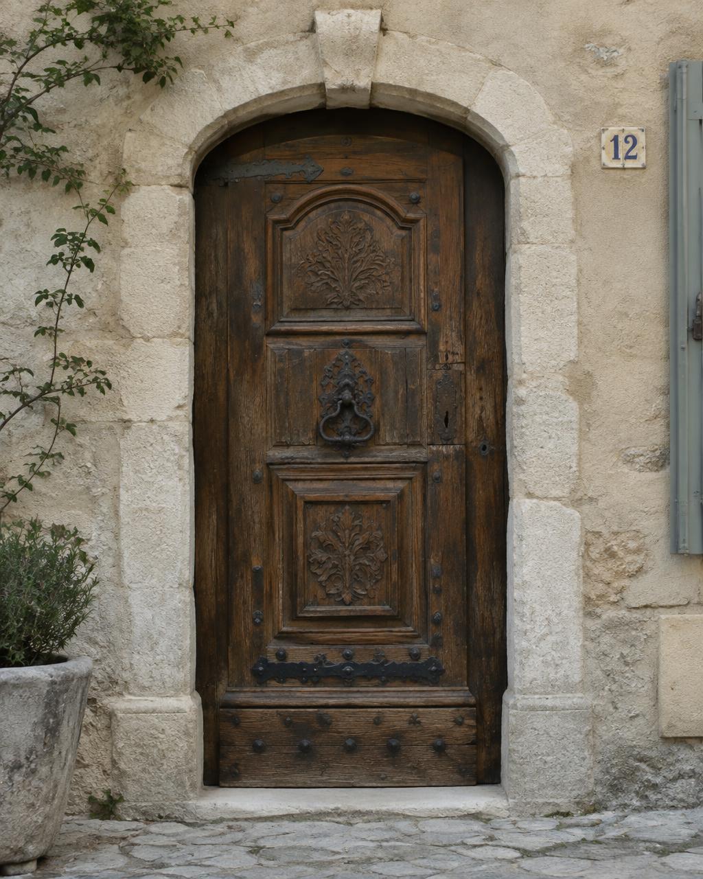 Porte ancienne en bois sculpté dans un encadrement de pierre